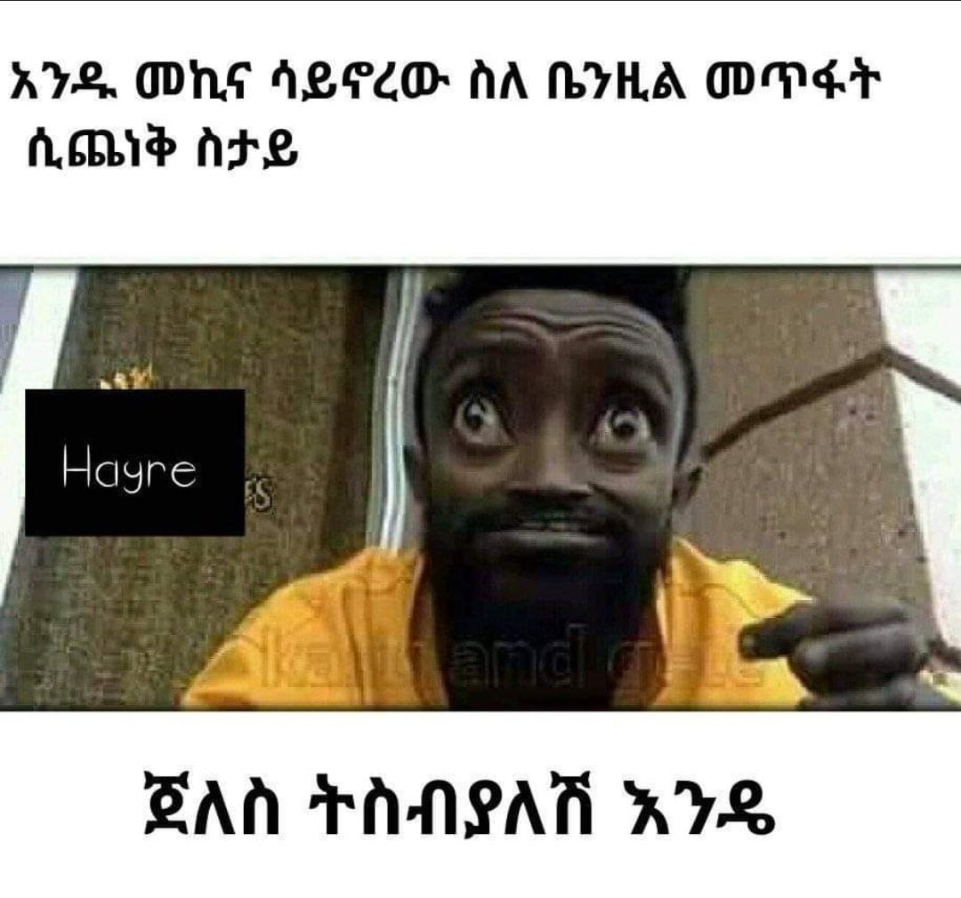 a man with a beard and a yellow shirt